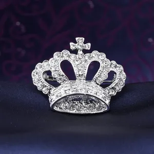 Crystal crown brooch detail shot, sparkling rhinestones on silver tone metal pin ornament.