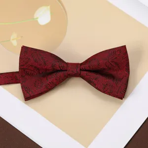 Detailed view of a dark red jacquard bow tie with subtle leaf pattern for men's business suit.