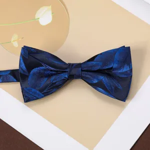 Close-up detail of blue jacquard bow tie with leaf pattern, ideal for formal business suits.