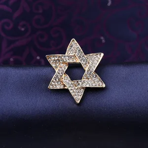 Close-up detail of a vintage gold rhinestone Star of David brooch, elegant suit accessory.