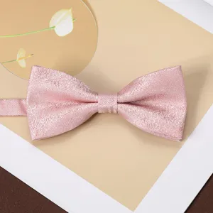 Close-up detail of a pink jacquard textured bow tie, ideal for formal suit and shirt styling.