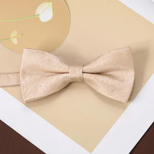 Champagne jacquard bow tie detail shot, showing textured fabric and refined men's style.
