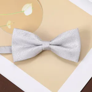 Close-up detail of a silver grey jacquard bow tie, elegant men's formal accessory.