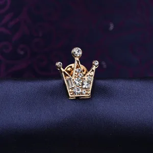 Detail view of a vintage gold crown brooch pin, sparkling clear crystal rhinestones, elegant.