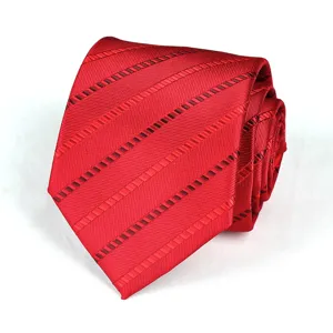 Close up view of a stylish red striped necktie detail, showing fine texture and pattern.