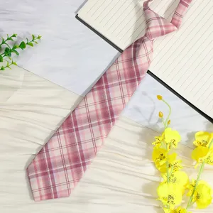 Detail shot of pink plaid JK necktie, pre-tied lazy style, sweet uniform accessory.