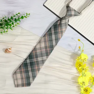 Japanese style plaid pre-tied short necktie detail shot, classic tartan pattern for school uniform.
