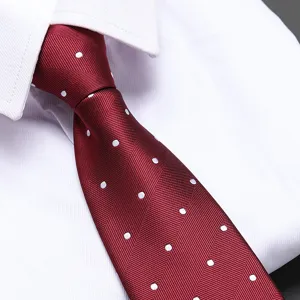 Red polka dot necktie detail shot, classic herringbone pattern formal business tie for men.