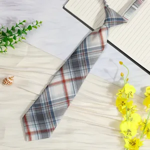 Close up detail of a Japanese JK style pre-tied plaid necktie with tartan pattern.