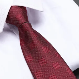 Close-up detail of a classic men's red textured business necktie paired with a white dress shirt.
