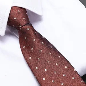Close-up of red-brown business tie with white square pattern, elegant formal neckwear detail.