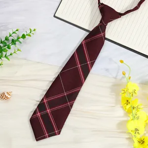 Close-up view of a burgundy Japanese style plaid pre-tied necktie for school uniform style.
