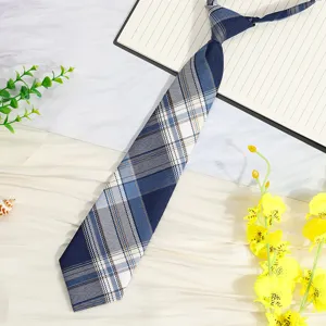 Detail shot of a Japanese style blue plaid pre-tied short necktie, school uniform accessory.