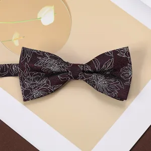 Detail view of a vintage men's burgundy floral jacquard bow tie for business shirts.