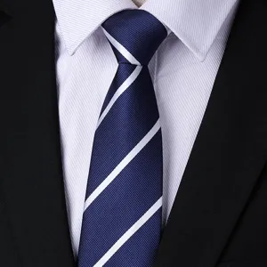 Close-up of classic navy blue necktie featuring clean white diagonal stripes and textured fabric.