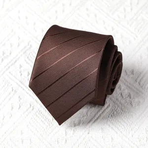 Close-up view of a brown striped tie, rolled neatly showing fine fabric texture and pattern.