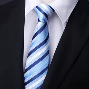 Close up detail of blue and white striped formal necktie displayed on shirt and suit.