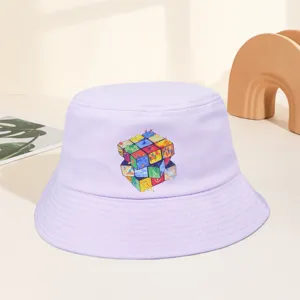 Detail view of a light purple bucket hat featuring a colorful artistic cube graphic print.
