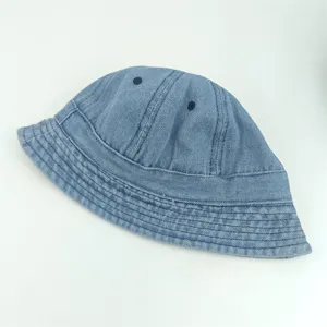 Close-up detail of the washed denim children's bucket hat, showing fabric texture and eyelets.