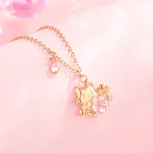 Close-up shot of the rose gold cat and cherry blossom pendant necklace, delicate details.