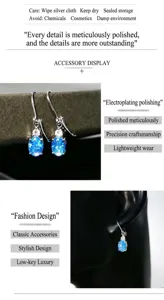 Vue détaillée de boucles d'oreilles en zircon ovale bleu, design de luxe élégant.