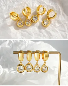 Detailed view of gold-plated cubic zirconia hoop earrings with chic round and teardrop charms.