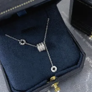 Closeup of silver multi-band ring pendant necklace detailed with sparkling crystals.