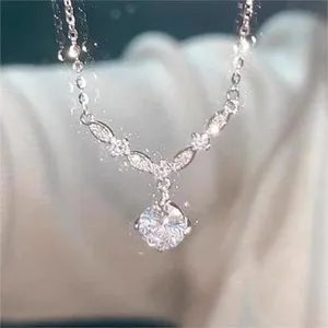 Close-up detail of the sparkling solitaire pendant necklace with delicate chain and crystal accents.