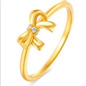 Elegant gold-plated bow ring with sparkling cubic zirconia, stylish open design for daily wear.
