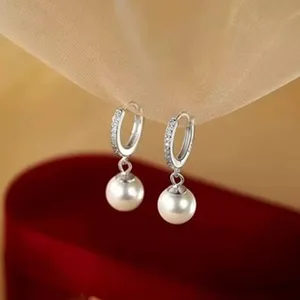 Elegant silver hoop earrings featuring sparkling zircon and classic dangling white pearls.