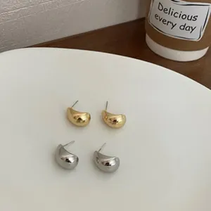 Gold silver teardrop metal stud earrings set close up detail minimalist fashion jewelry