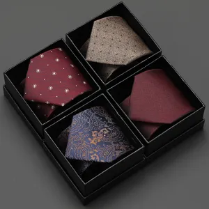 Details of the luxury men's tie gift set featuring four assorted classic patterns in black boxes.