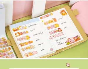 Detail shot of cute cartoon planner sticky notes and diary sticker book with daily schedules.
