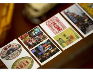 Close up of vintage style retro diary stickers with neon street scenes and hotel label designs.
