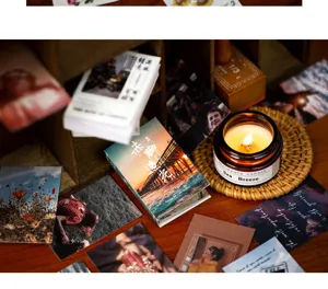Aesthetic detail shot of vintage sticker mini booklet with retro cards and a scented candle.