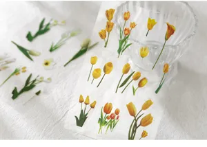 Close-up detail of transparent PET tulip stickers, fresh floral plant design for DIY crafts.