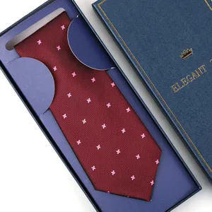 Detailed view of the elegant maroon necktie with pink floral pattern in blue box.