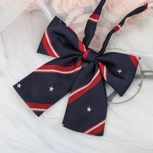 Detailed view of dark blue JK uniform bow tie with red white stripes and cute stars detail.