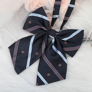 Detailed close-up of dark blue JK uniform bow tie with striped pattern and cute embroidery.