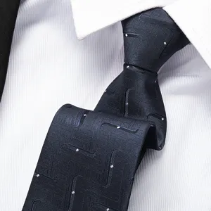 Close-up detail of a dark blue business tie with subtle geometric pattern on crisp white shirt.
