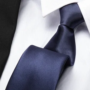 Close-up detail of a classic navy blue business tie with fine texture and elegant knot.