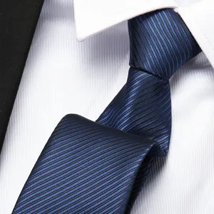 Close-up of professional blue striped zipper necktie on a crisp white dress shirt detail.