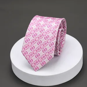Close-up of pink patterned men's tie, intricate geometric floral jacquard detail texture.