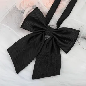 Close-up of black twill JK uniform bow ribbon, showing delicate texture and neat shape.