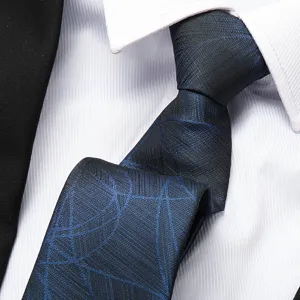 Close-up detail of dark blue geometric textured business necktie with white shirt collar and suit.