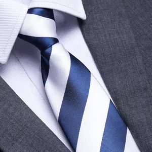 Close-up detail view of blue white striped men tie paired with professional shirt and suit.