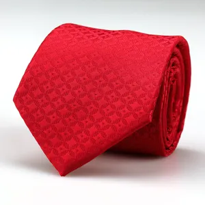 Red silk-like tie detail showing fine woven geometric pattern and rolled texture for men.