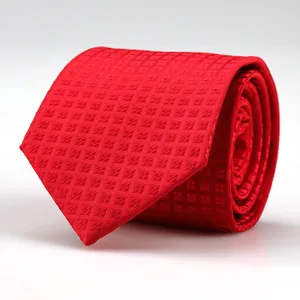 Detailed close-up view of the fine geometric textured fabric on the classic red men tie.