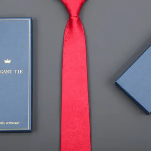 Detailed view of elegant red tie with floral pattern, perfect for business formal wear.