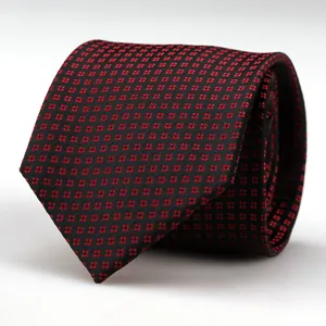 Men's black and red patterned formal business necktie detail, elegant wedding suit accessory.